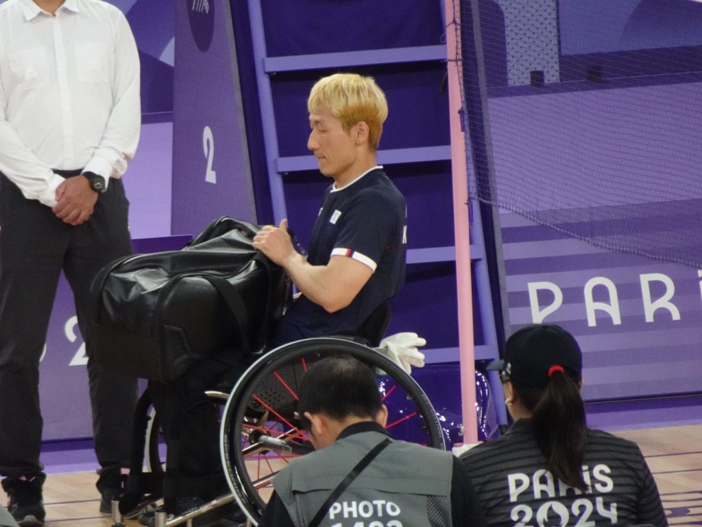 A para badminton player in a wheelchair on court