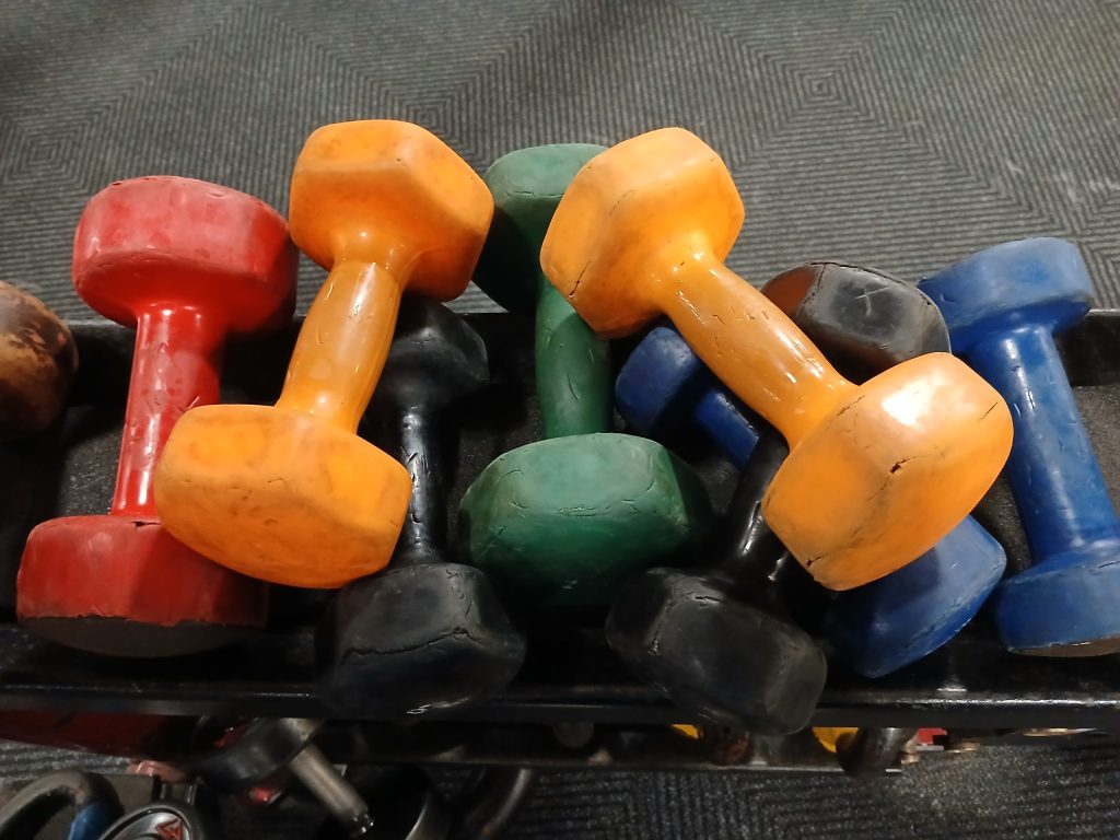 A pile of dumbbells at a gym