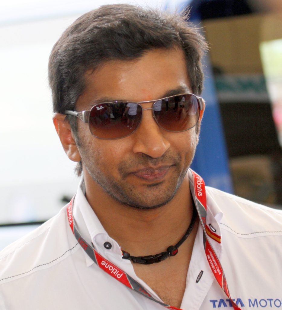 Narain Karthikeyan in sunglasses and a white team shirt