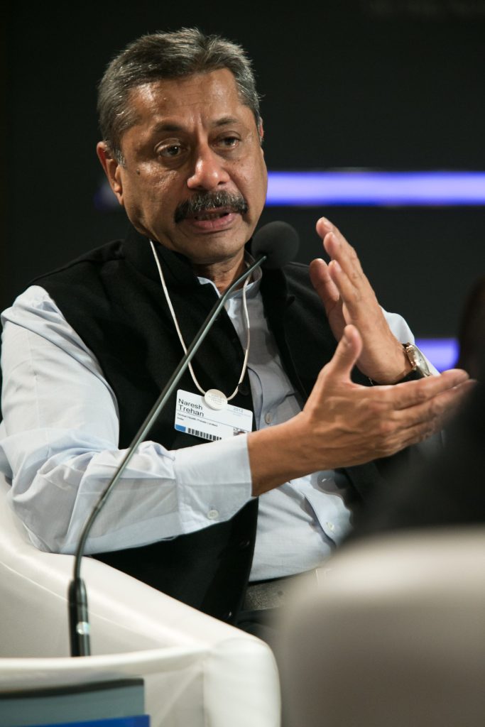 Naresh Trehan in a dark suit speaking at a conference