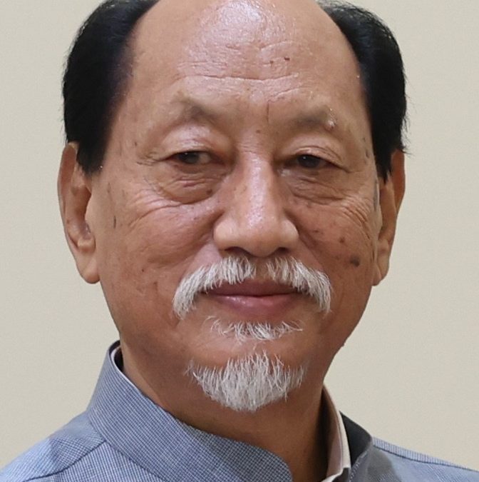 Neiphiu Rio with a white goatee, in a grey bandhgala