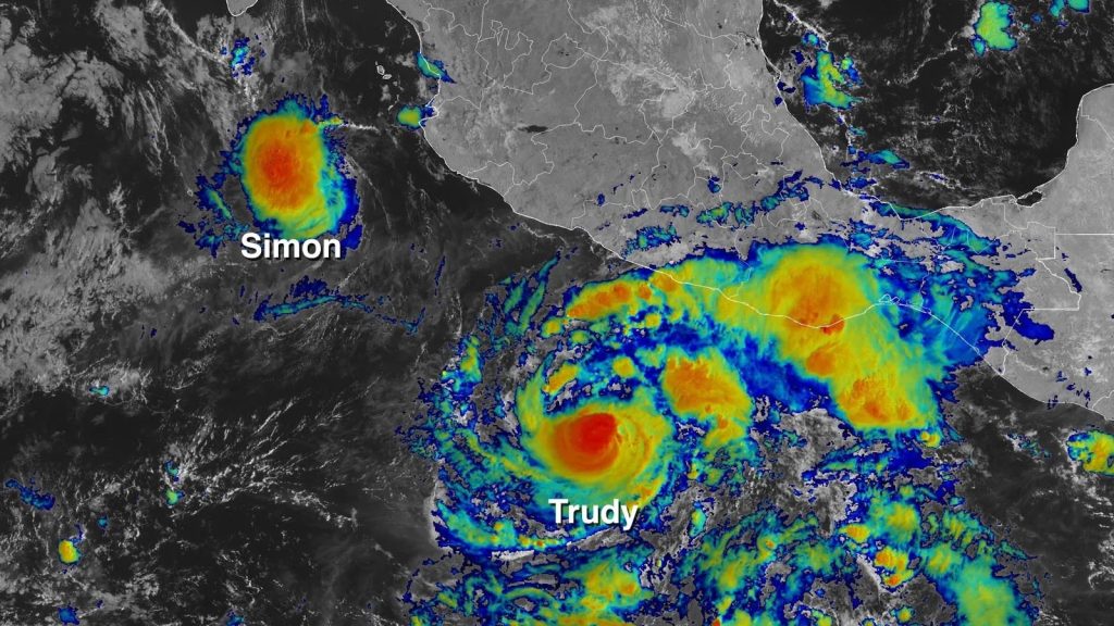 Colour-enhanced satellite image of two tropical systems labelled Simon and Trudy off the Pacific coast of Mexico