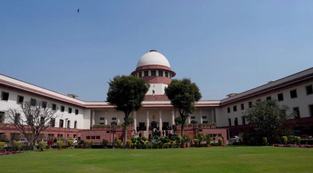 The domed Supreme Court of India building and its lawn in New Delhi under a clear sky