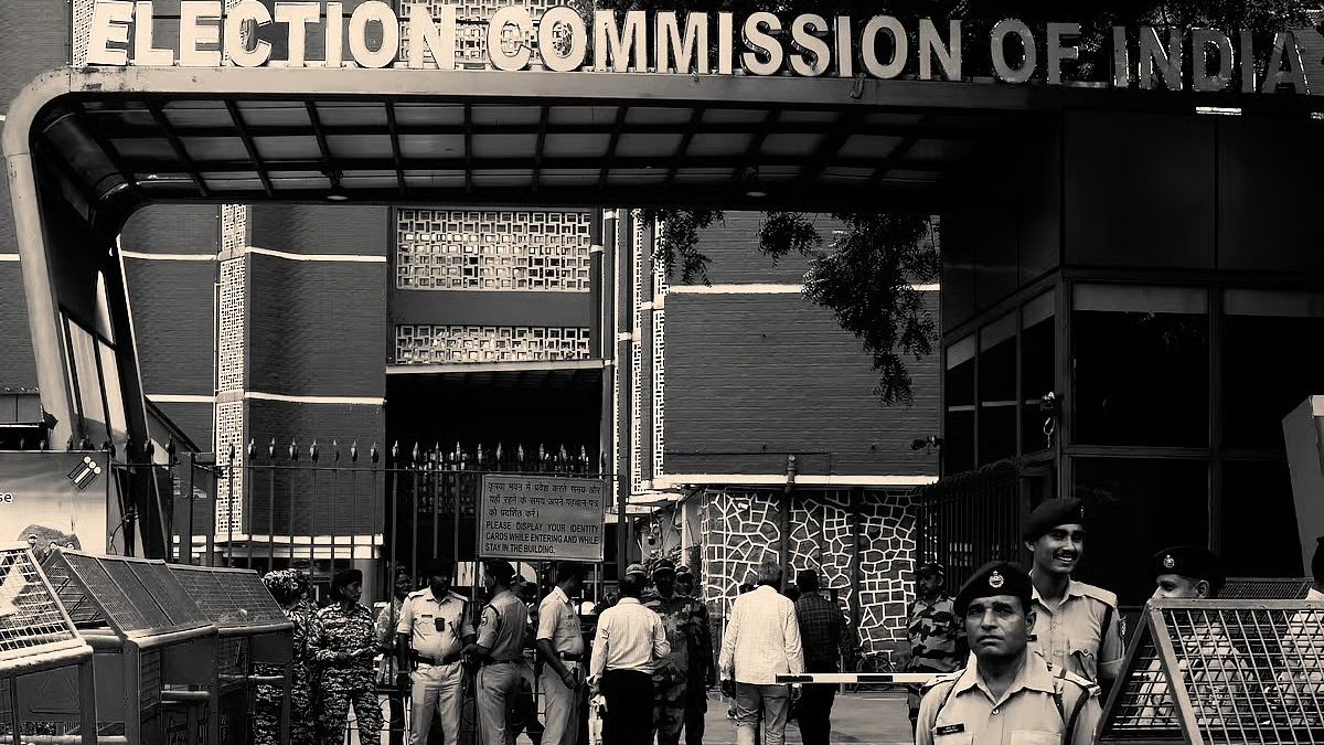Black-and-white view of the Election Commission of India entrance in New Delhi with security personnel standing in front of it