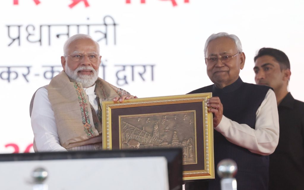 Nitish Kumar presenting a framed artwork to Prime Minister Narendra Modi
