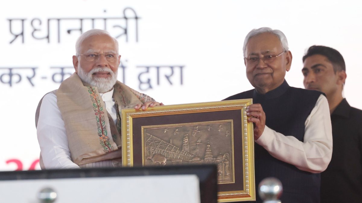 Nitish Kumar presenting a framed artwork to Prime Minister Narendra Modi