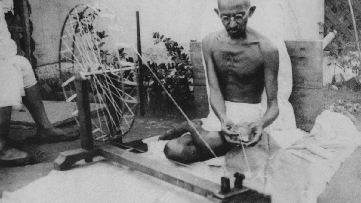 Mahatma Gandhi spinning cotton on a charkha