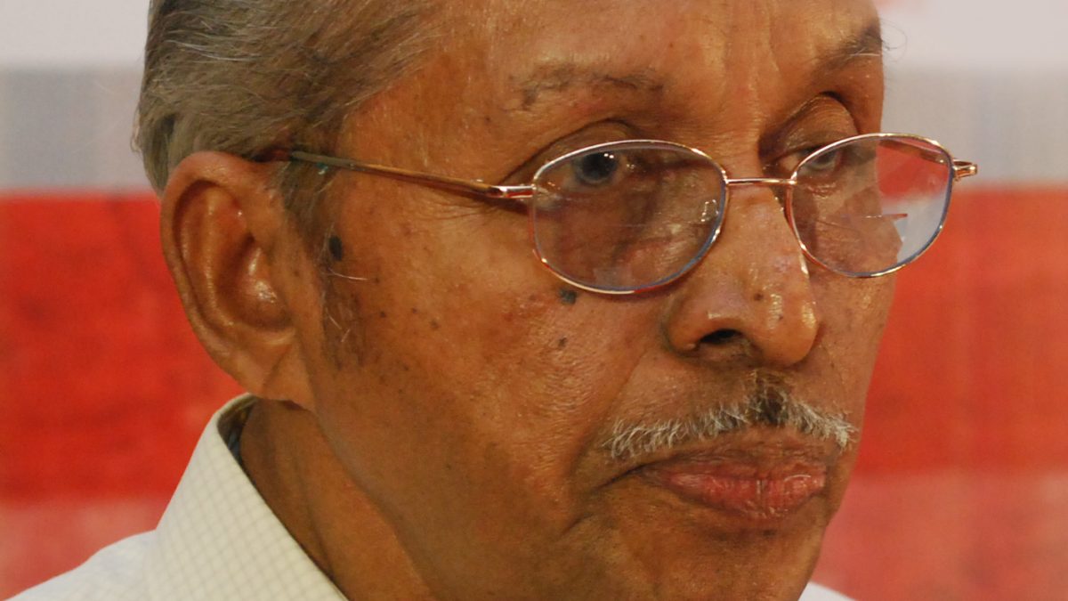 O. N. V. Kurup in glasses and a cream shirt, looking to one side