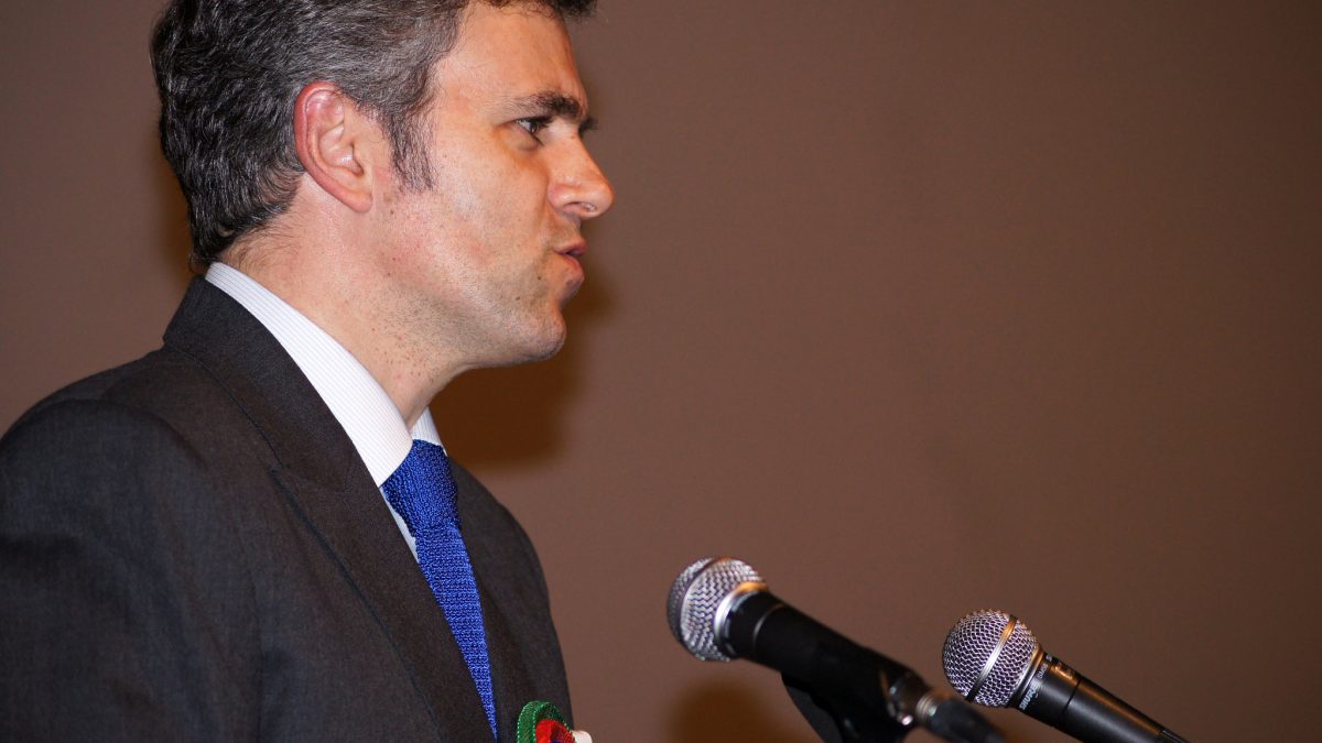 Omar Abdullah speaking at a podium with two microphones
