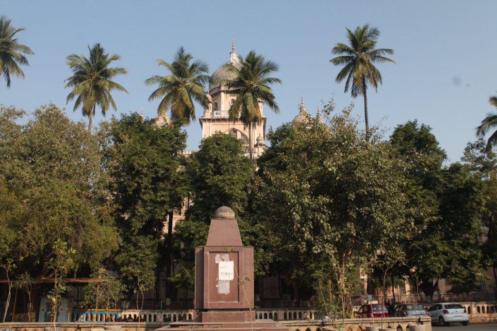 The Osmania General Hospital building seen behind trees in Hyderabad