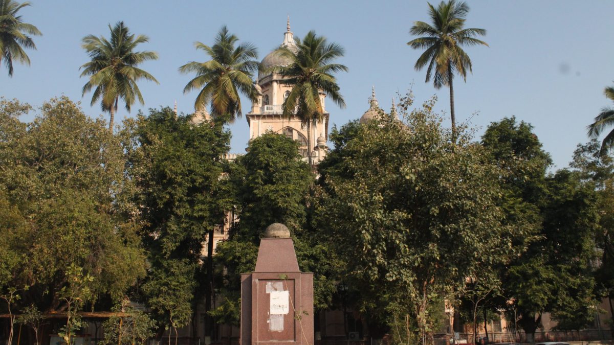 The Osmania General Hospital building seen behind trees in Hyderabad