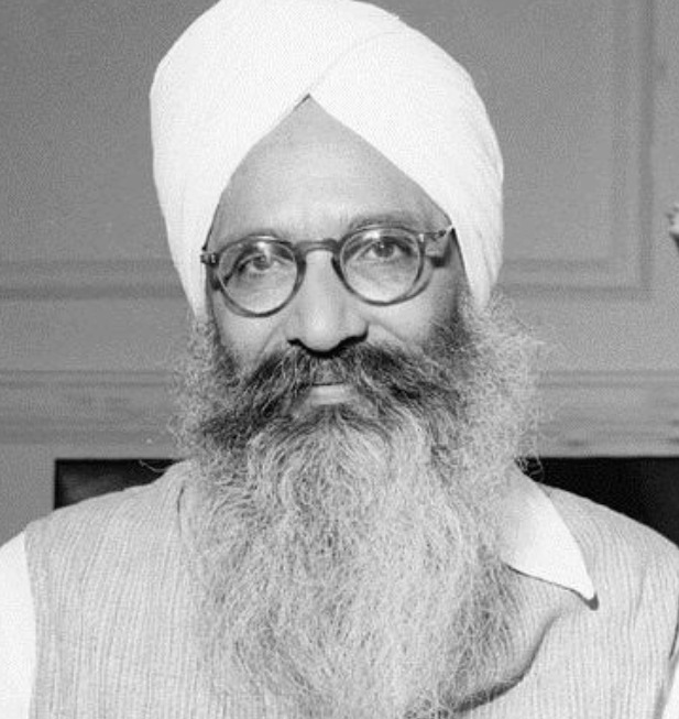 A black-and-white portrait of Partap Singh Kairon in a white turban and glasses