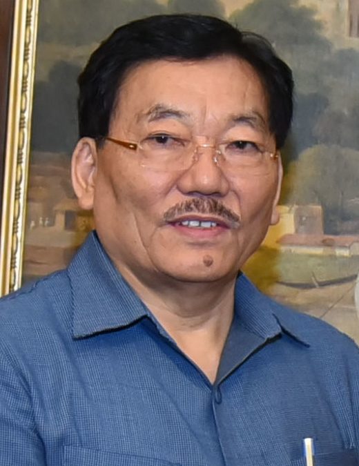 Pawan Kumar Chamling in glasses and a blue shirt