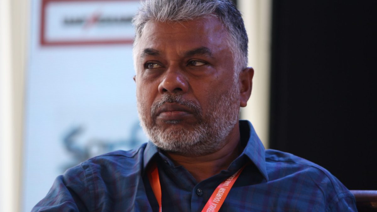 Perumal Murugan with grey hair in a blue checked shirt at a literature festival