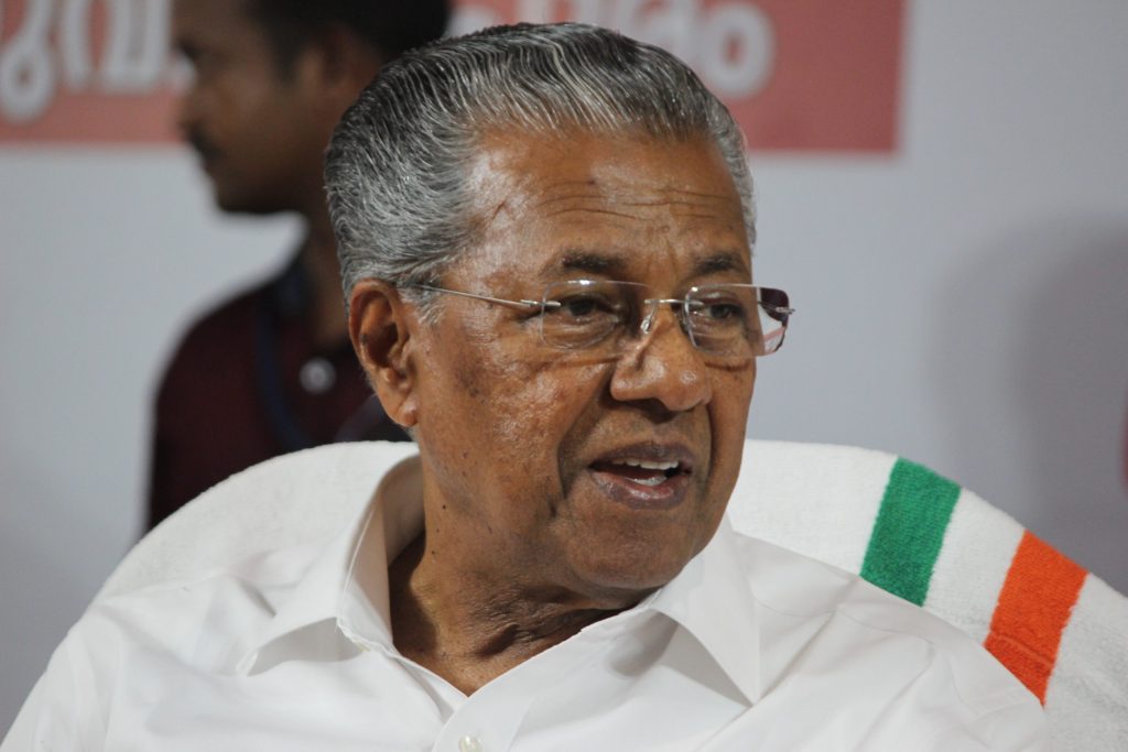 Close-up of Pinarayi Vijayan in glasses and a white shirt, speaking