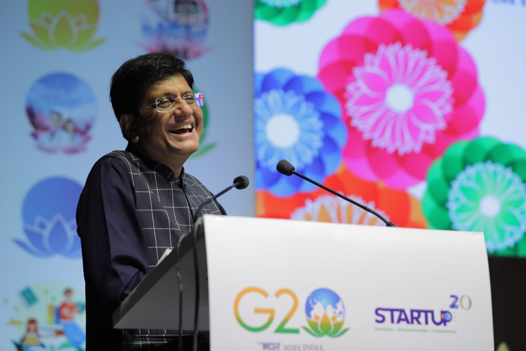 Union Commerce Minister Piyush Goyal speaking at a podium during the G20 Startup20 summit in Gurugram