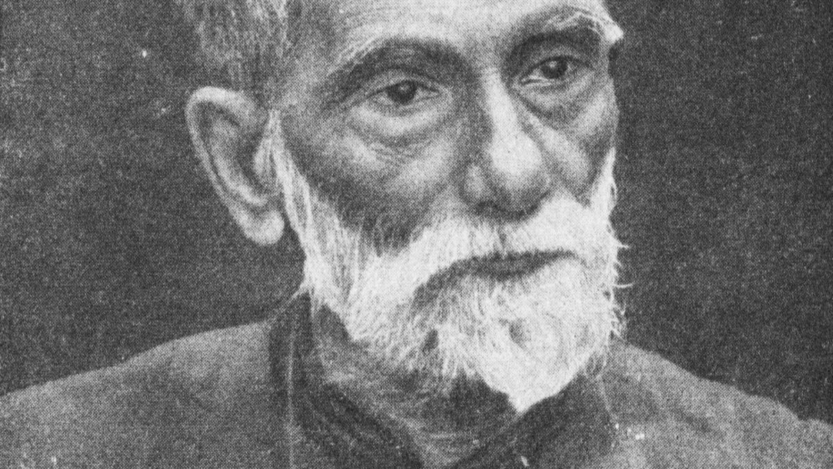 Black-and-white portrait of an elderly Prafulla Chandra Ray with white hair and beard