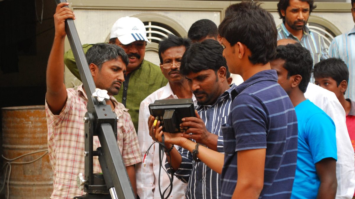A film crew gathered around a camera during a shoot in Karnataka