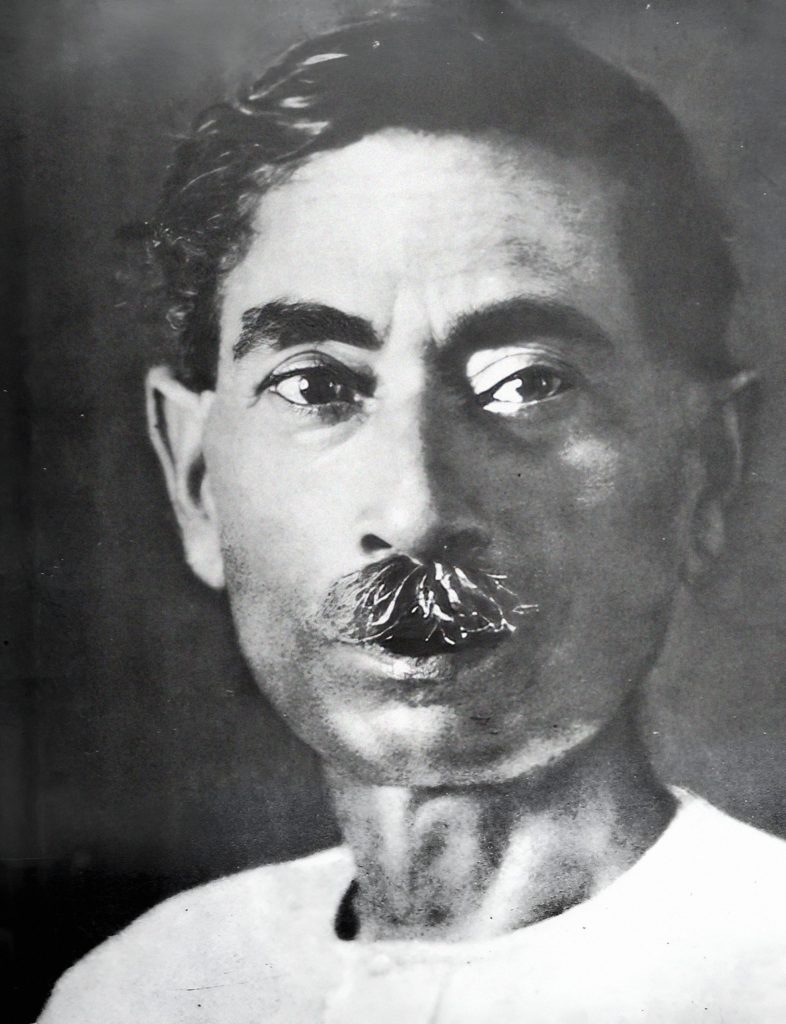 Black-and-white portrait of Premchand with a thick moustache, in a white kurta