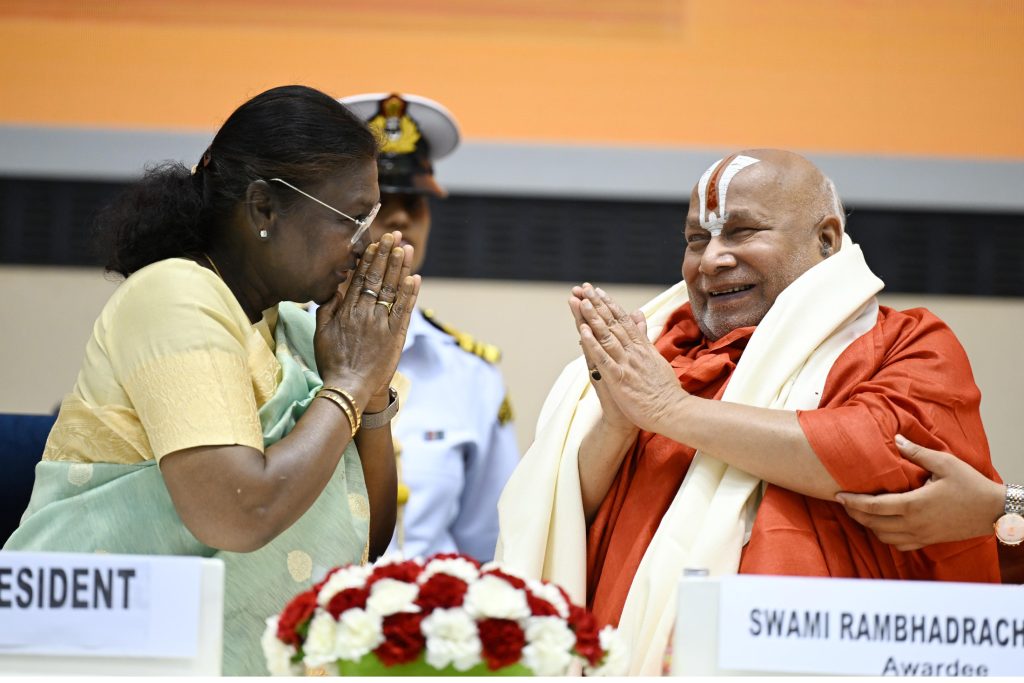 President Droupadi Murmu with her hands folded in greeting beside Swami Rambhadracharya