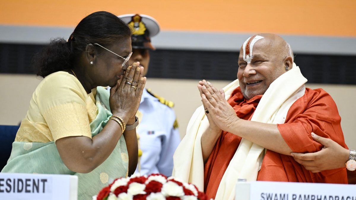 President Droupadi Murmu with her hands folded in greeting beside Swami Rambhadracharya