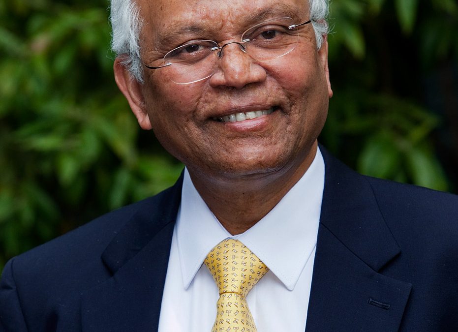 R. A. Mashelkar in glasses, a dark suit and a yellow tie, smiling