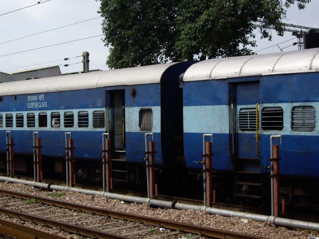 Blue Indian Railways sleeper coaches at a station