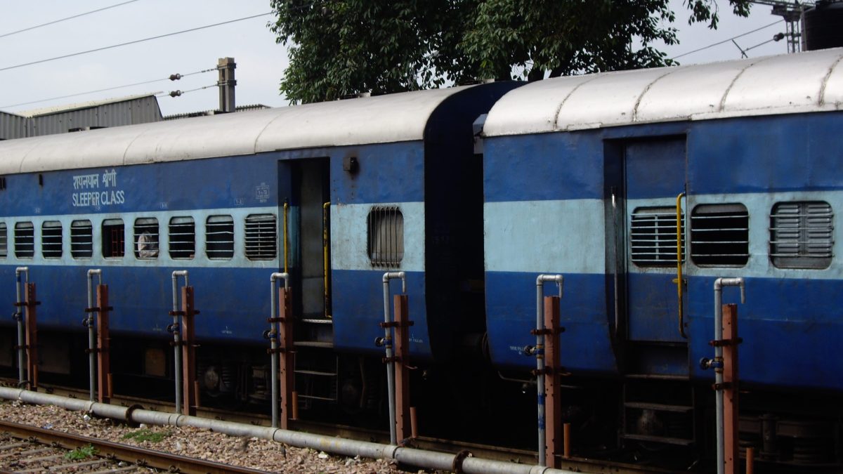 Blue Indian Railways sleeper coaches at a station