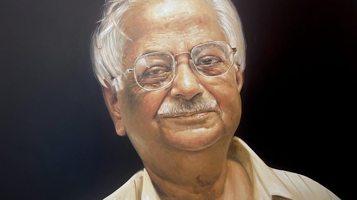 An oil painting of a smiling Raja Ramanna with white hair and glasses