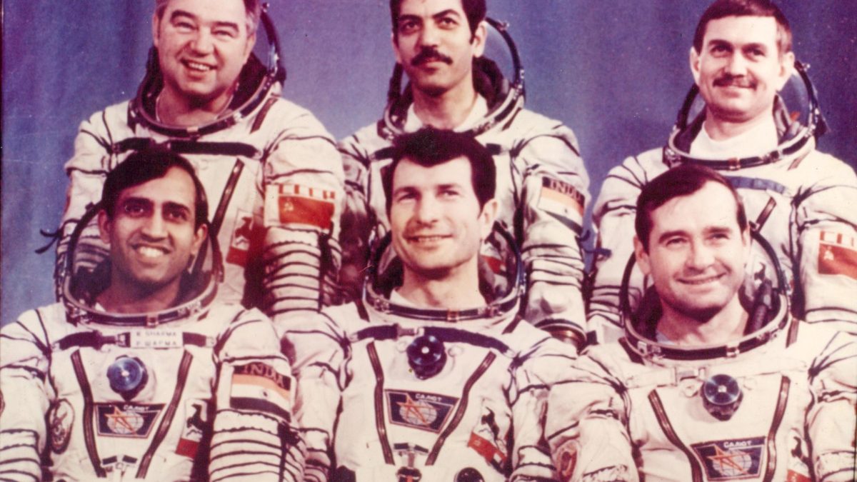 Six cosmonauts in white spacesuits, among them Rakesh Sharma, posing for an official photograph