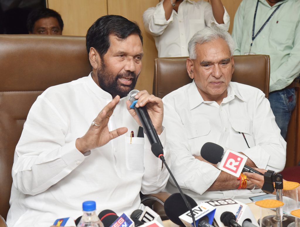 Ram Vilas Paswan in a white kurta speaking into a microphone at a press conference