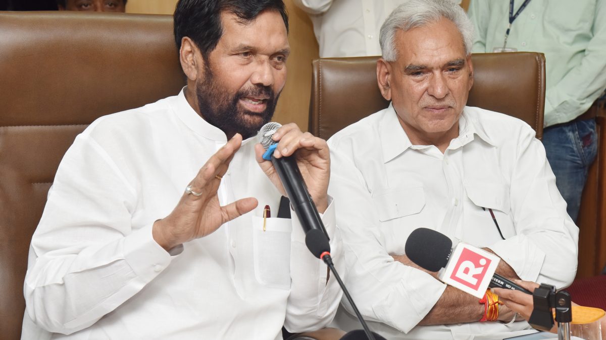 Ram Vilas Paswan in a white kurta speaking into a microphone at a press conference