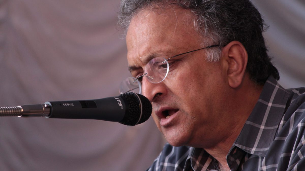 Close-up of Ramachandra Guha in glasses speaking into a microphone