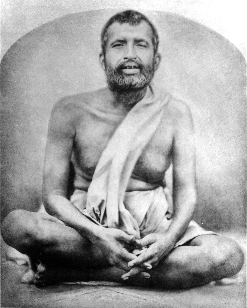 Photograph of Ramakrishna seated cross-legged with his hands folded in his lap