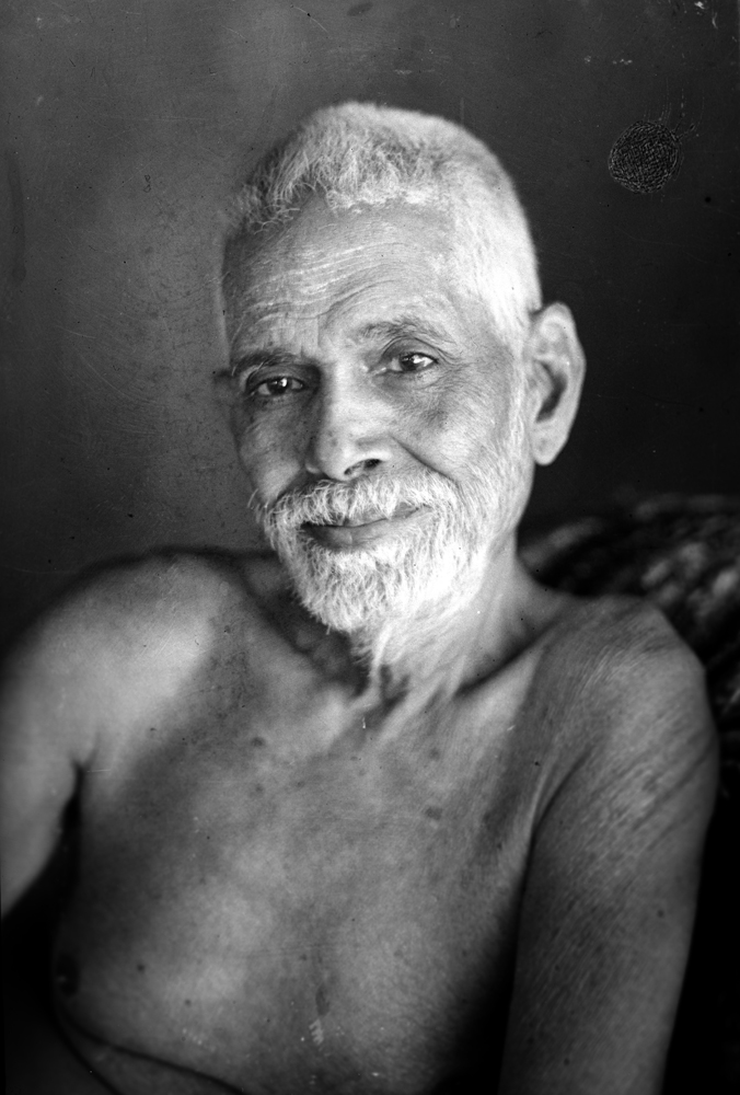 Black-and-white portrait of Ramana Maharshi with white hair and beard, bare-shouldered