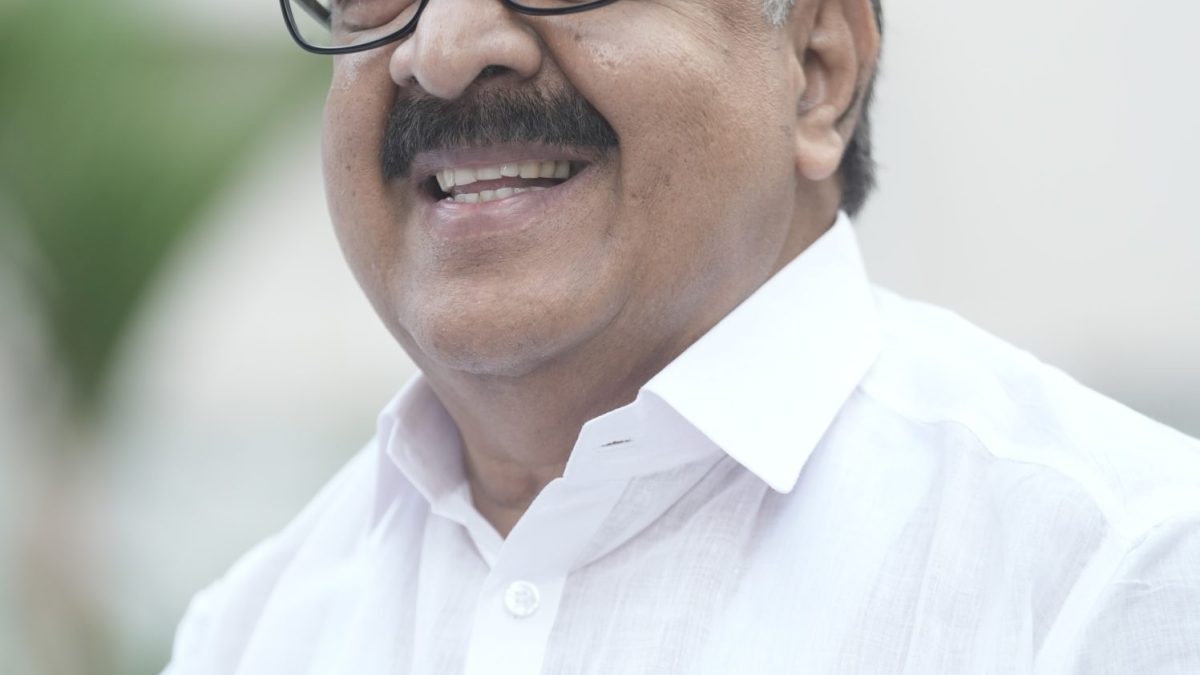 Ramesh Chennithala in glasses and a white shirt, smiling