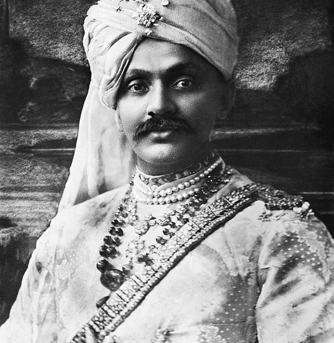 A black-and-white portrait of Ranjitsinhji in a jewelled turban and princely dress