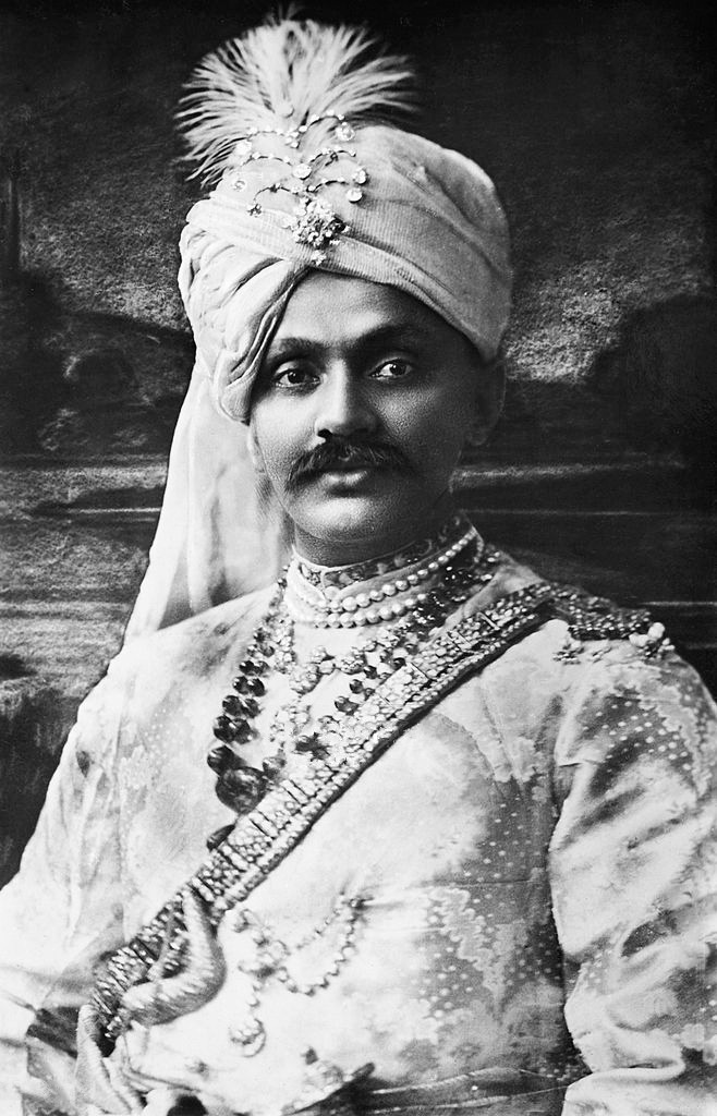 A black-and-white portrait of Ranjitsinhji in a jewelled turban and princely dress