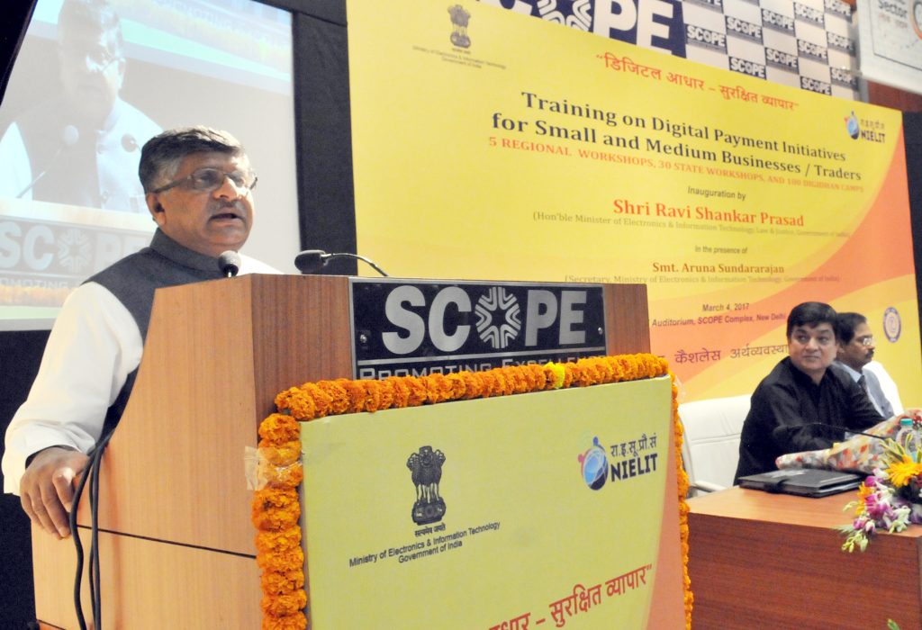 Ravi Shankar Prasad in a white kurta and dark waistcoat speaking at a lectern