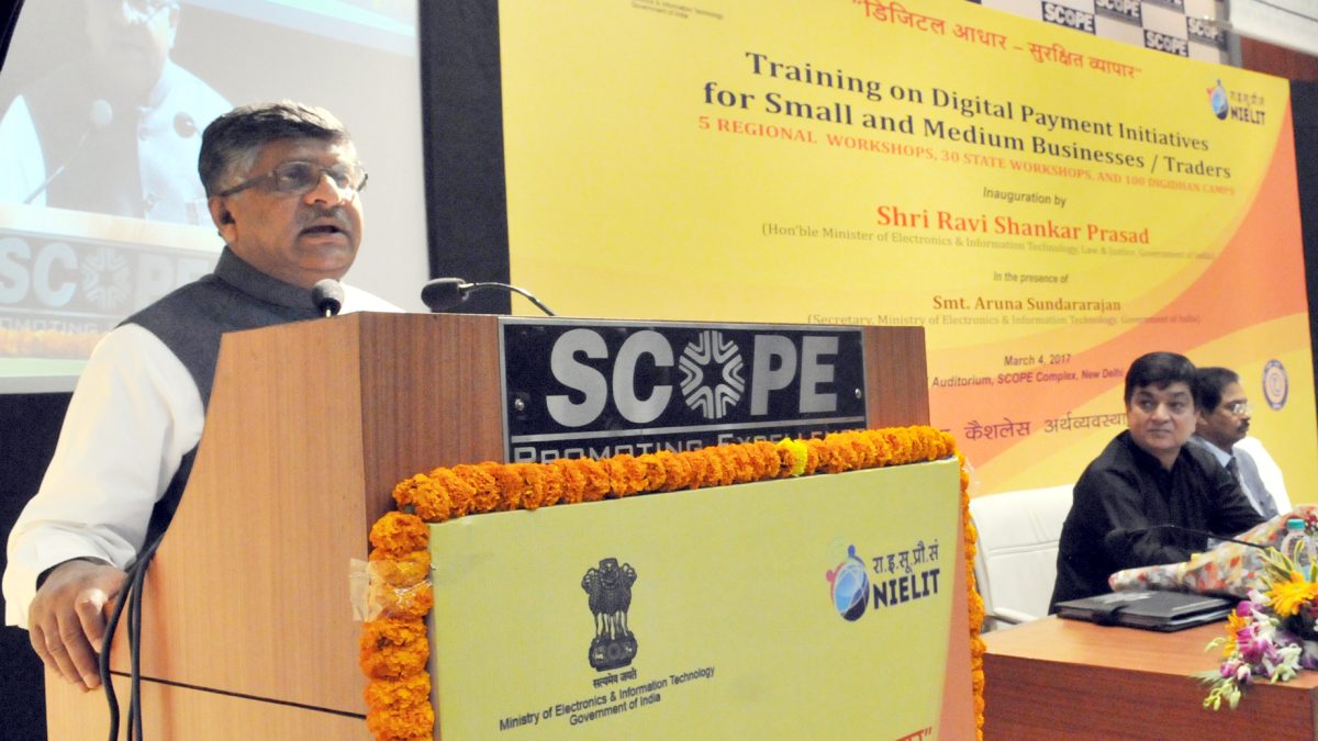 Ravi Shankar Prasad in a white kurta and dark waistcoat speaking at a lectern