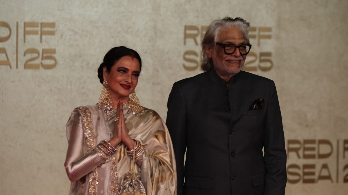 Rekha greeting with folded hands beside director Muzaffar Ali at the Red Sea Film Festival
