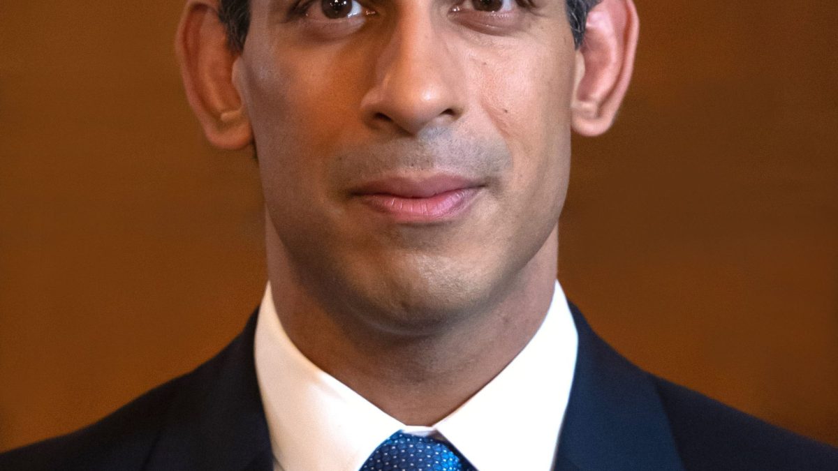 Official portrait of Rishi Sunak in a dark suit and tie
