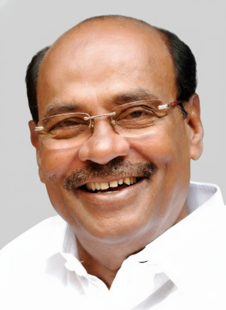 Dr S. Ramadoss in glasses and a white shirt, laughing
