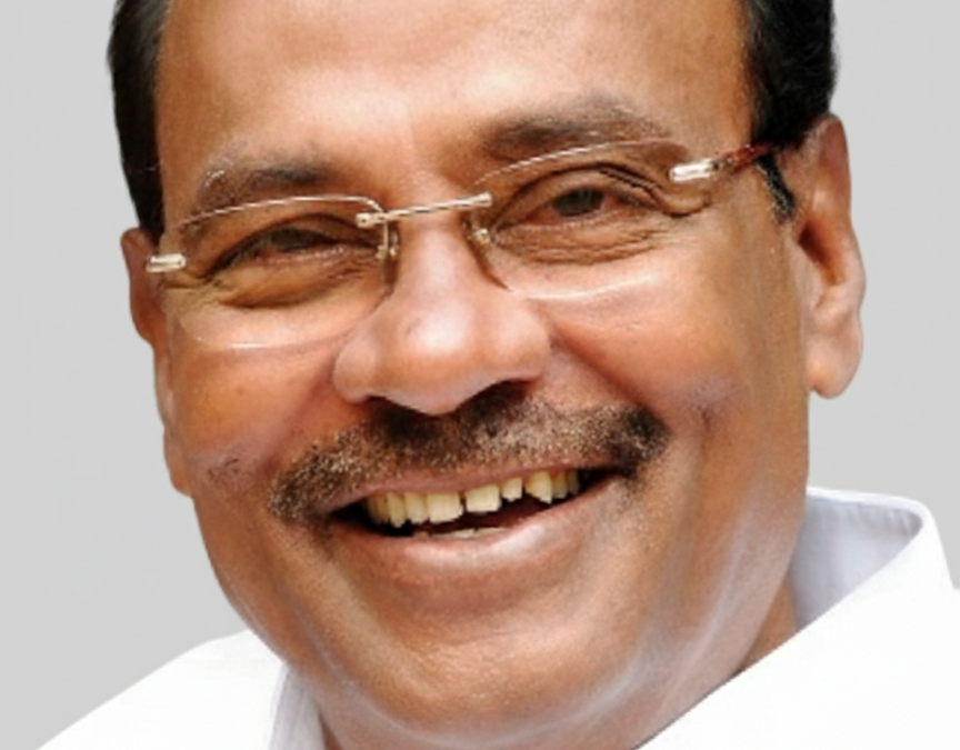 Dr S. Ramadoss in glasses and a white shirt, laughing