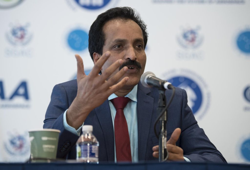 S. Somanath in a blue suit gesturing as he speaks into a microphone