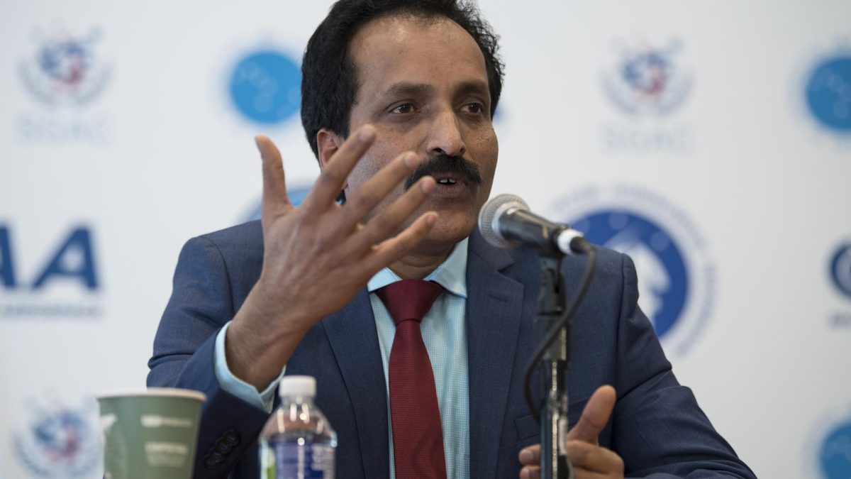 S. Somanath in a blue suit gesturing as he speaks into a microphone