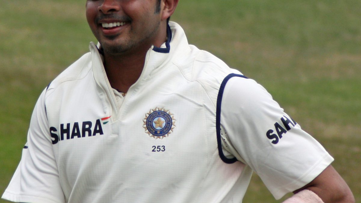 S. Sreesanth in India's white kit and blue cap, running in the outfield