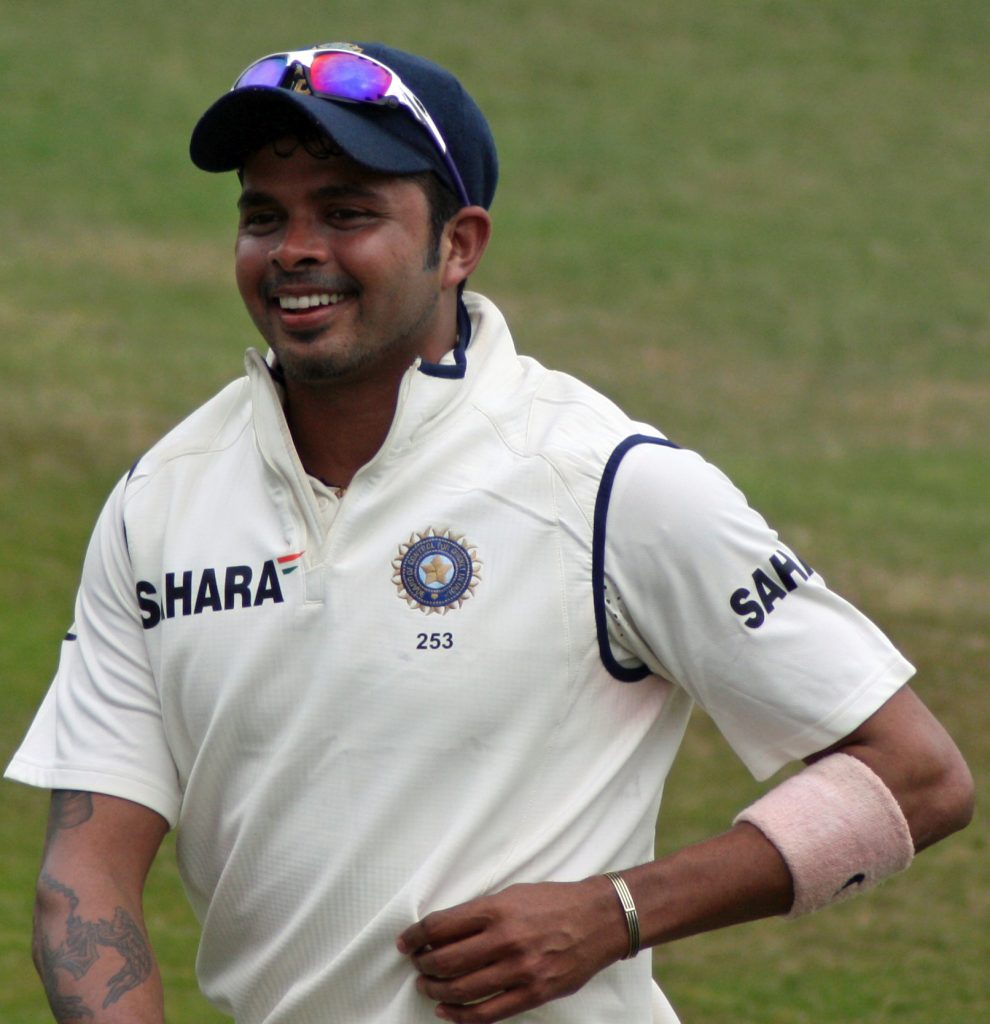 S. Sreesanth in India's white kit and blue cap, running in the outfield