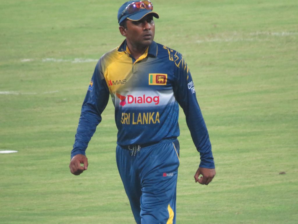 Mahela Jayawardene walking on the field in a Sri Lanka shirt
