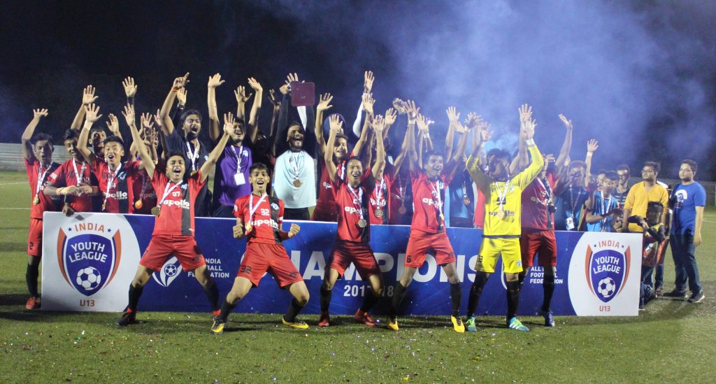 Players and officials celebrating after winning a Youth I-League title